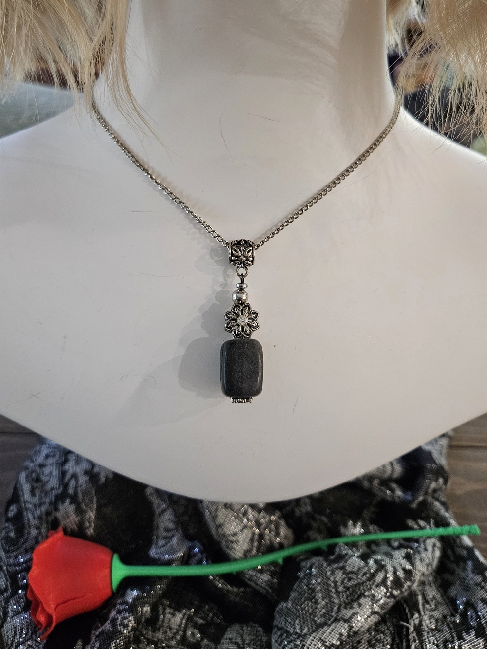 silver-tone necklace with black stone pendant